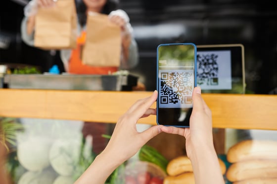 A person using a smartphone to scan a product barcode