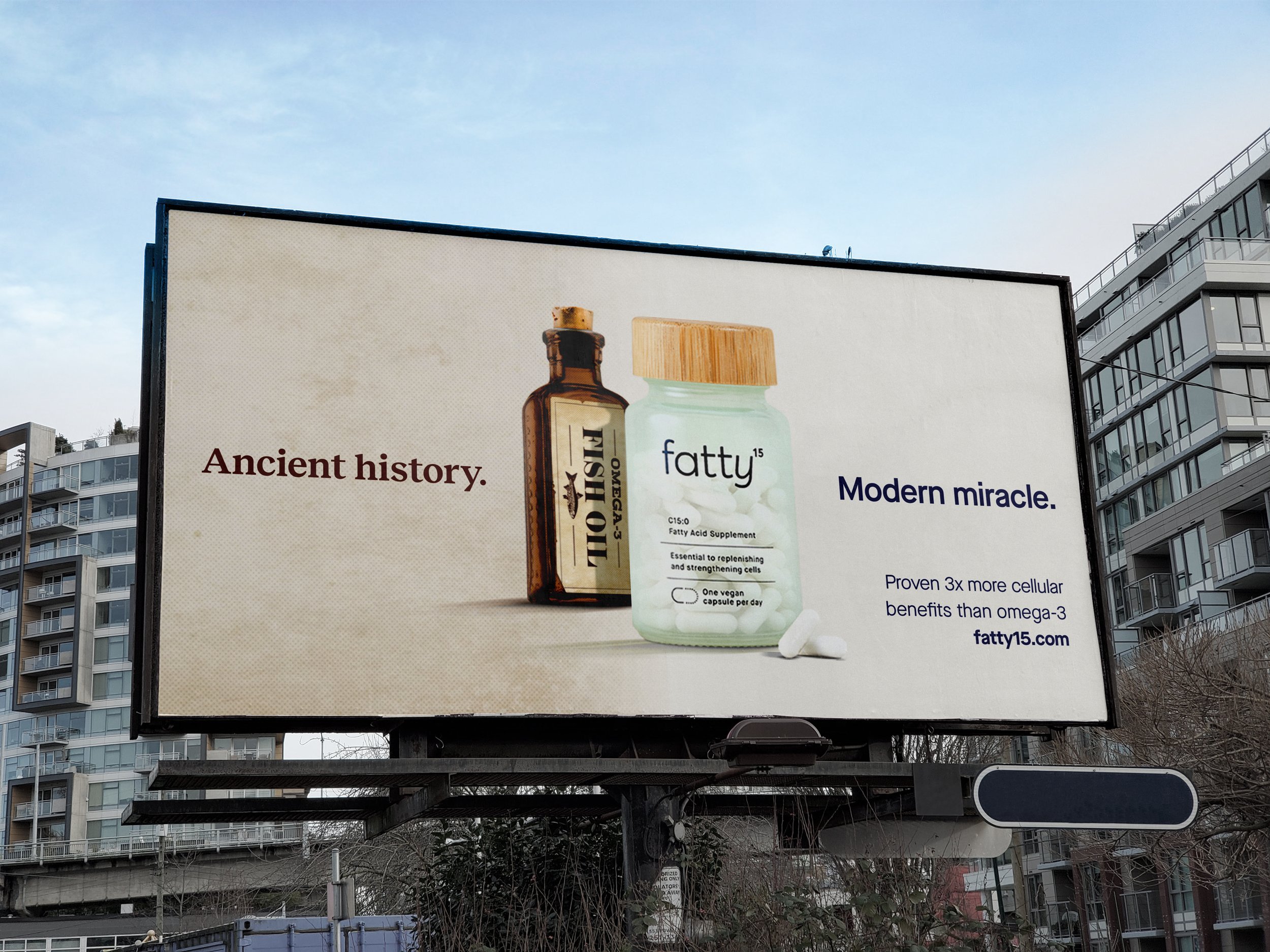 A billboard shows a brown old fashioned bottle on the left labeled "omega 3 fish oil" and the headline "Ancient History." On the right, a clean bottle of fatty15 supplements with the headline "Modern Miracle."