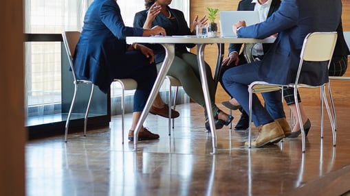 Group of CEOs in a meeting room around a table