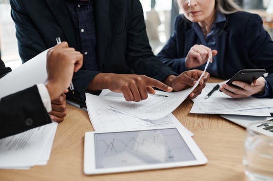 Executives sitting around a table Reviewing Research Data